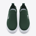 Straight-on dark green slip-on sneakers with textured uppers and white soles