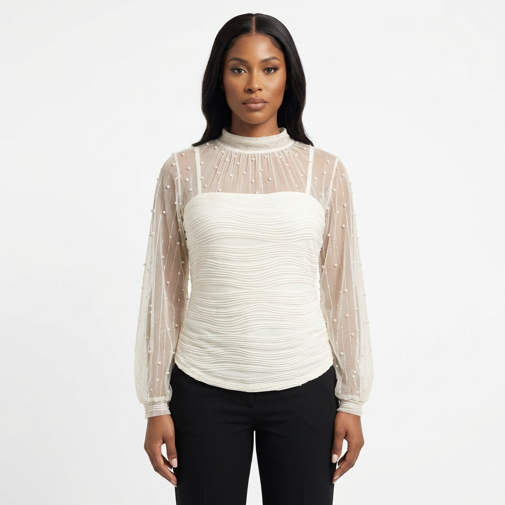 Black female model wearing an ivory dotted sheer-sleeve ruched blouse on white