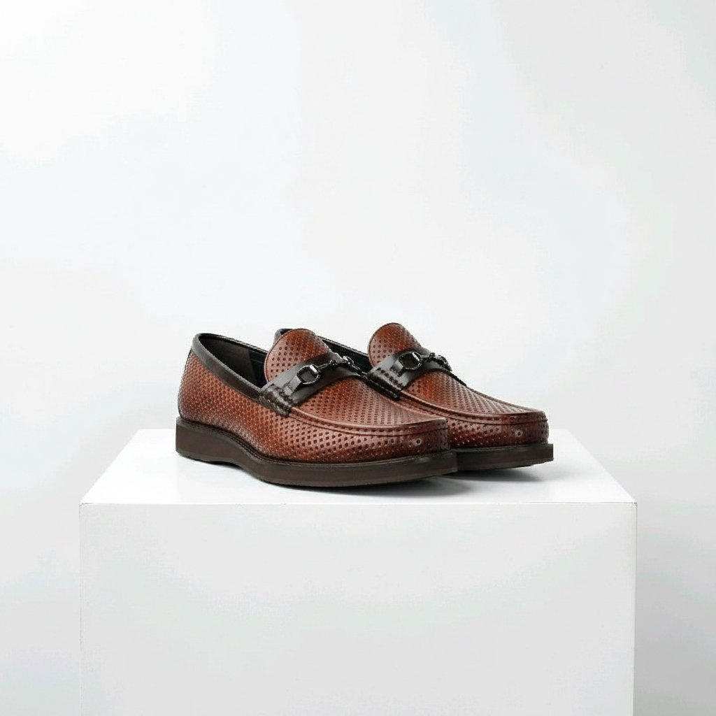 Men's brown perforated leather horsebit loafer shoes pair on white platform
