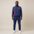 Model wearing the navy and red two-piece tracksuit