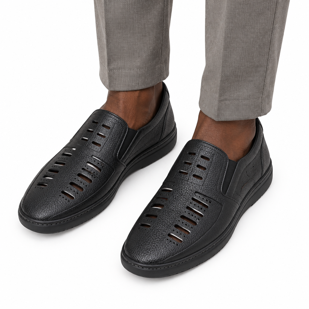 Adult model wearing black textured cutout slip-on shoes