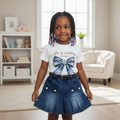 Young Nigerian girl aged 3-6 wearing the She Is Worthy graphic tee and denim skirt set