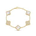 Gold-tone white clover and stone charm bracelet on white