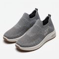 Pair of grey knit slip-on sneakers on white