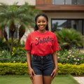 Nigerian female model wearing red Solution graphic top