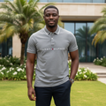 Nigerian male model wearing grey marl polo shirt in garden setting
