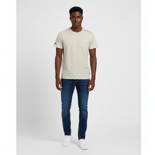 Young Nigerian male wearing sand beige nautical 68 crew neck tee with shoulder tape detail