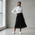 Nigerian teenage girl wearing black pleated glitter midi skirt