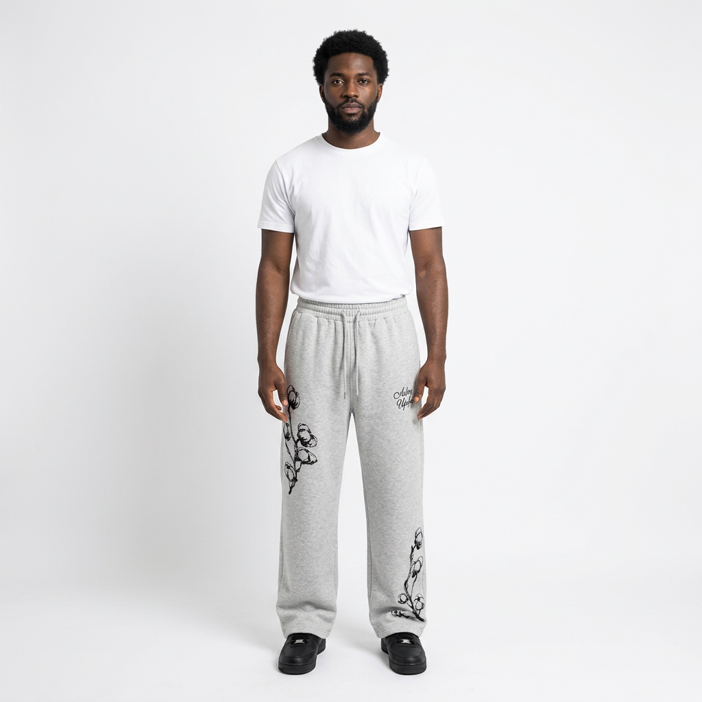 Full-body adult Black man wearing light-grey black-floral wide-leg trousers
