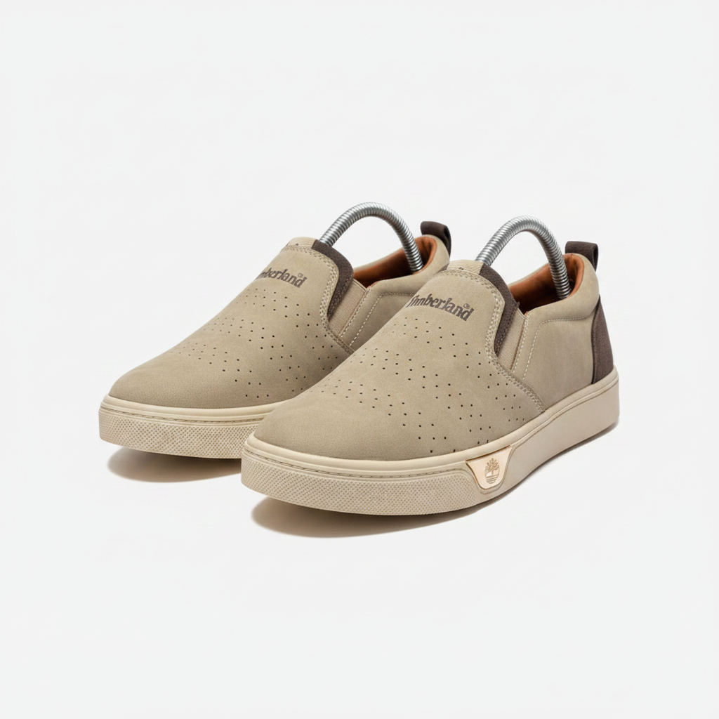 Sand suede slip-on sneakers with cream sole, centred on a plain off-white background