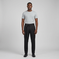 Full-body male model wearing black asymmetric-waist pleated trousers