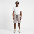 Full-body model wearing light grey drawstring shorts