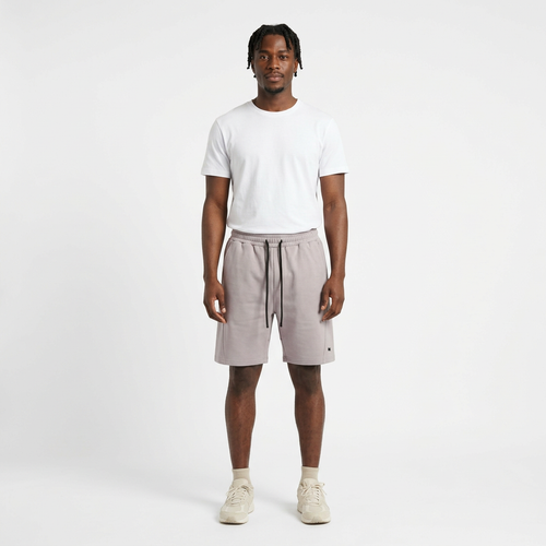 Full-body model wearing light grey drawstring shorts