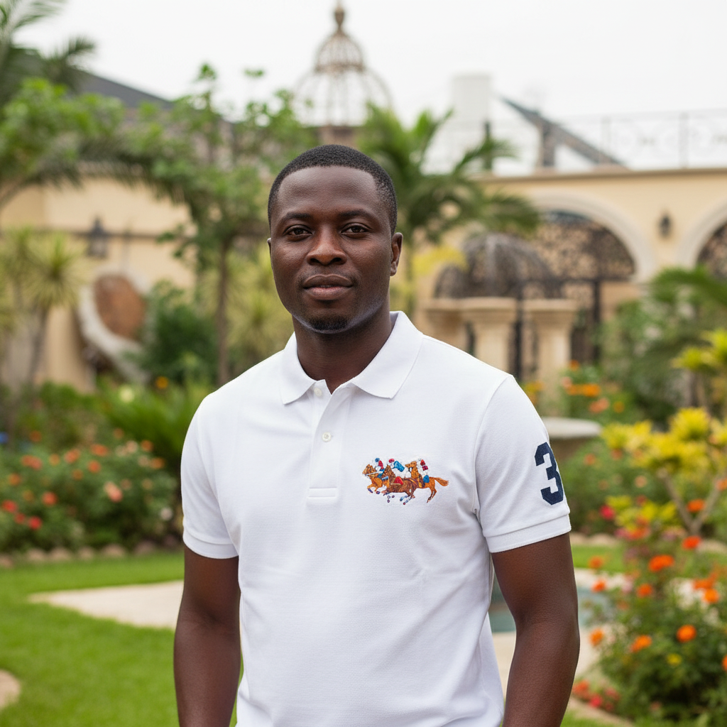 Nigerian male model wearing white polo shirt with equestrian embroidery in garden setting