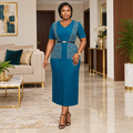 Adult Black woman wearing a teal V-neck patterned dress
