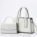 White contrast-edge tote and matching flap handbag on white background
