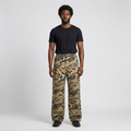 Full-body male model wearing wide-leg camouflage cargo trousers