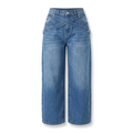 Washed blue wide-leg jeans with crossover denim straps on a white background