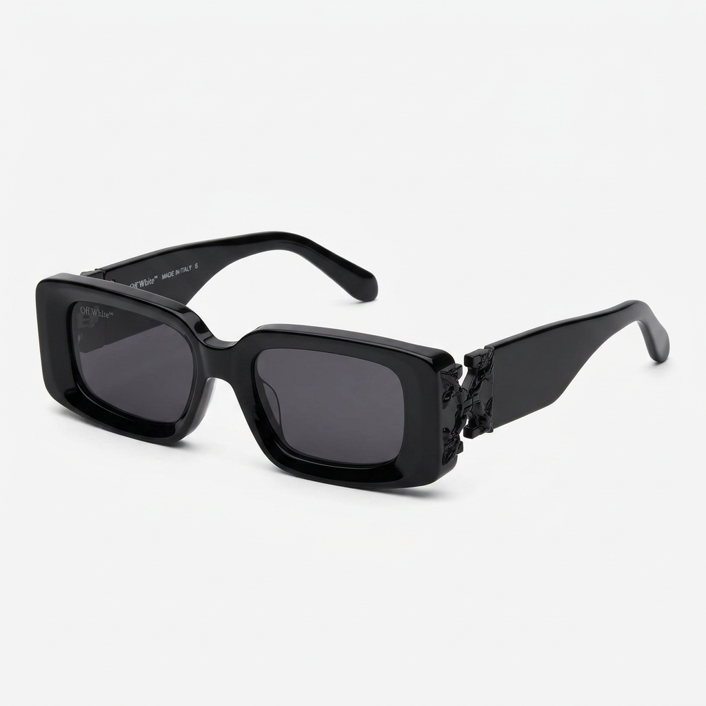 Chunky glossy black rectangular sunglasses with sculpted corners on white