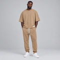 Nigerian male model wearing camel oversized t-shirt and jogger tracksuit set