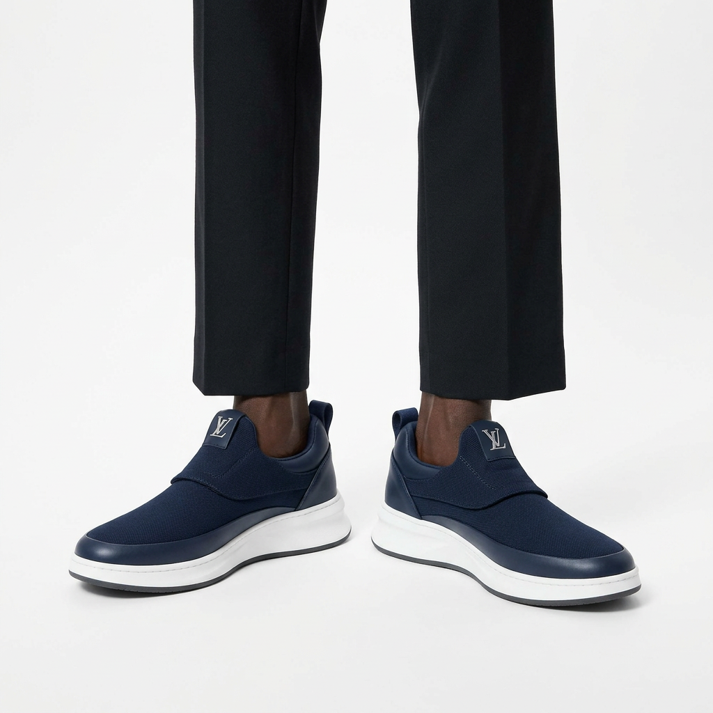 Men's navy slip-on trainers worn with black ankle trousers