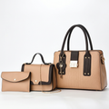 Light-tan three-piece handbag set with black trim, embossed tote, flap bag and pouch on white