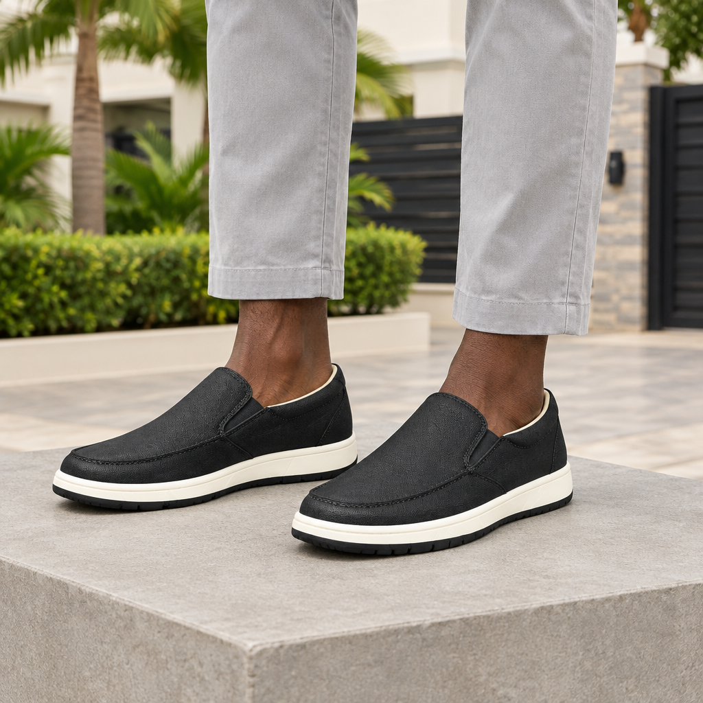 Man wearing black moc toe slip-on sneakers with grey chinos