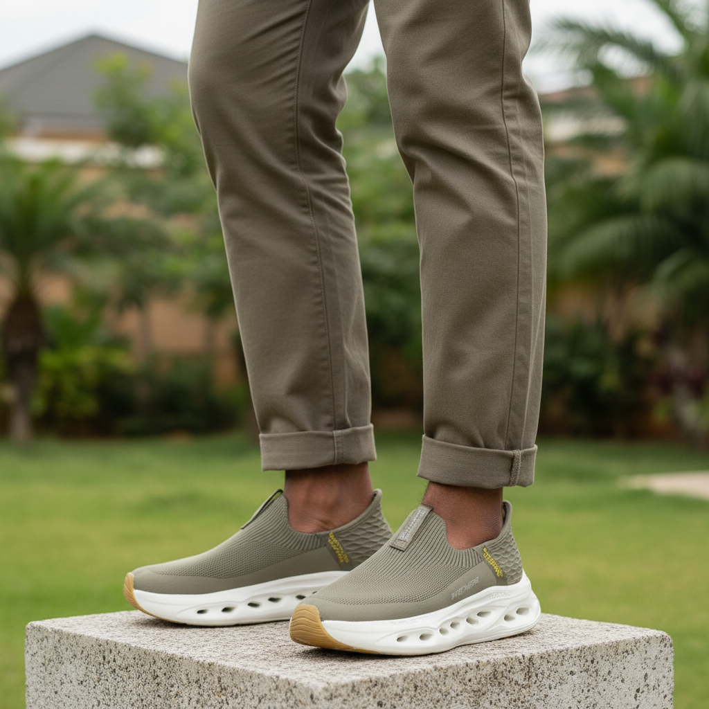 Men's olive khaki slip-on sneakers leg-focus lifestyle shot Nigerian male model