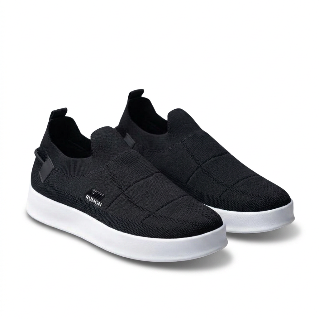 Pair of black knit slip-on sneakers with white soles on a pure-white background