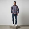 Nigerian male model wearing navy blue red plaid long-sleeved shirt, front view