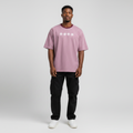 Young Nigerian male wearing dusty mauve Spacedive Explorer Astrospace oversized graphic tee