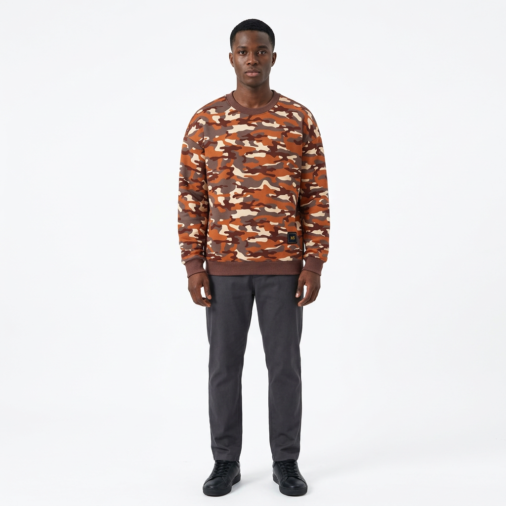 Full-body male model wearing a rust-orange and brown camouflage sweatshirt