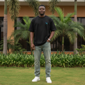 Nigerian male model wearing black geometric X emblem minimal oversized tee – front view