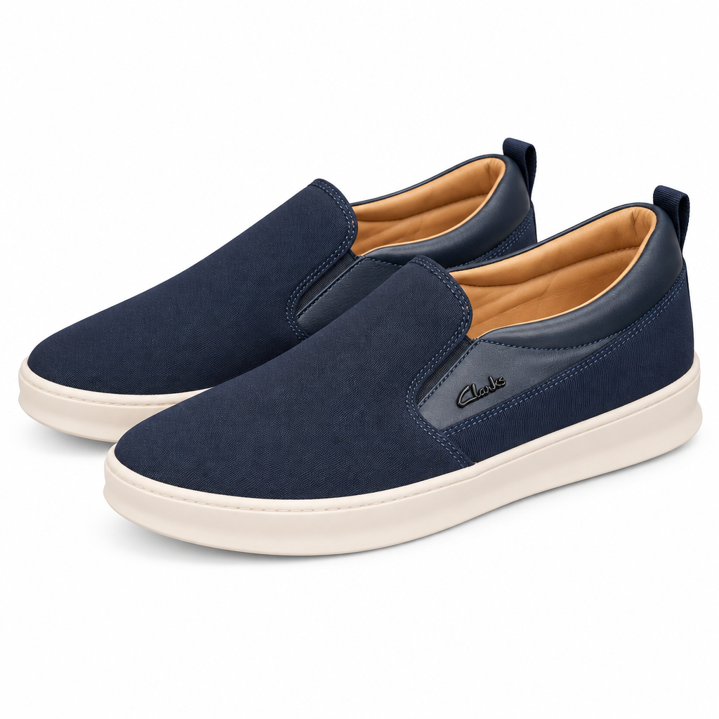 Pair of navy smooth-trim slip-on sneakers with cream soles on white