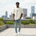 Young Nigerian male model wearing cream New York Manhattan graphic oversized tee