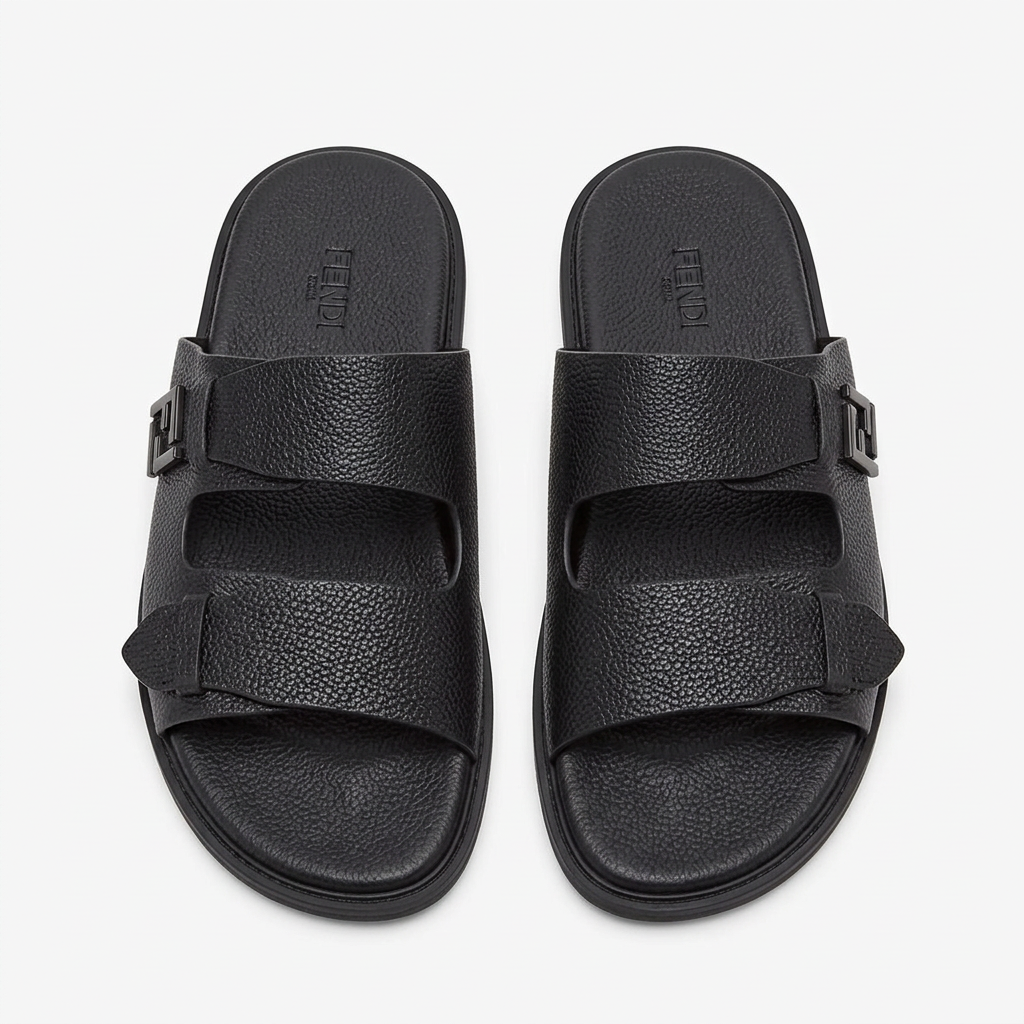 Pair of black pebbled double-strap slides on white
