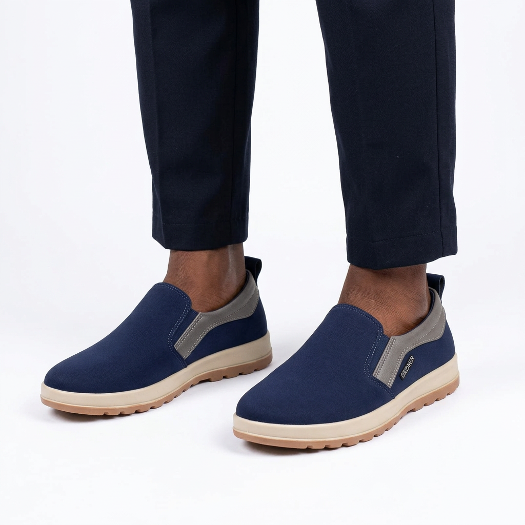 Navy grey-trim slip-on shoes worn by a Nigerian male model on white