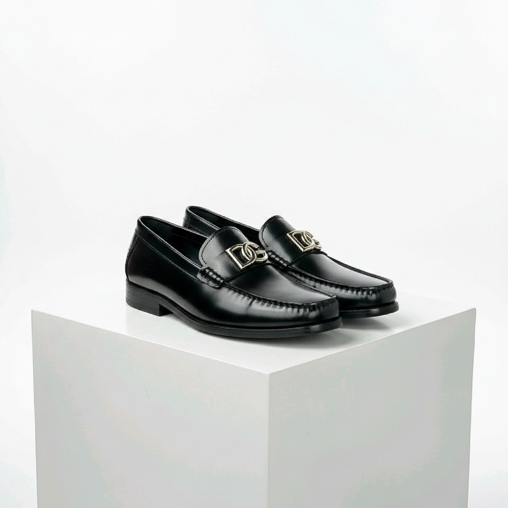 Men's black smooth leather gold hardware loafer shoes pair on white platform