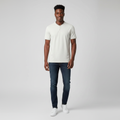 Young Nigerian male wearing light stone Henley black tipped polo shirt