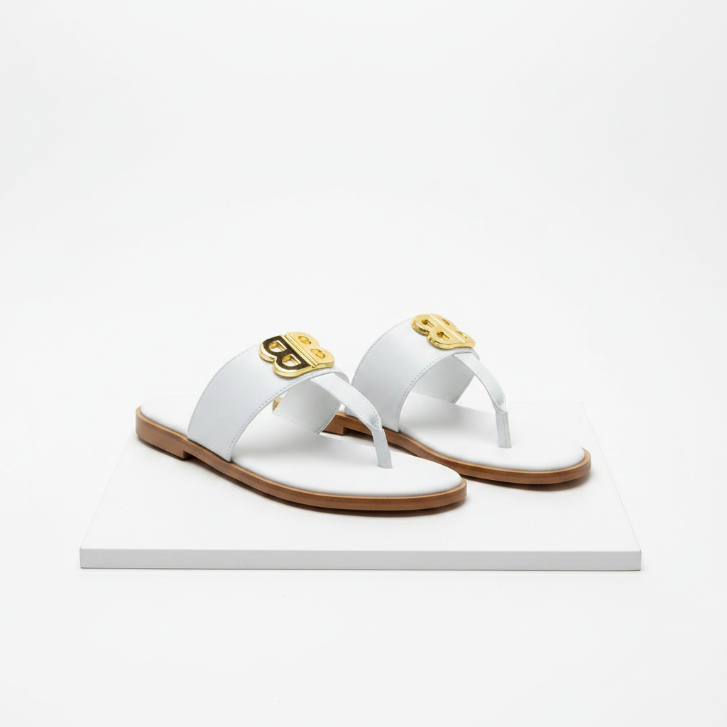 Men's white leather gold emblem thong sandals pair on white platform