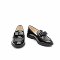 Black croc-embossed patent leather loafer pair with bow detail — ghost mannequin product shot