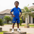 Nigerian child model wearing royal blue football jersey set with white football boots