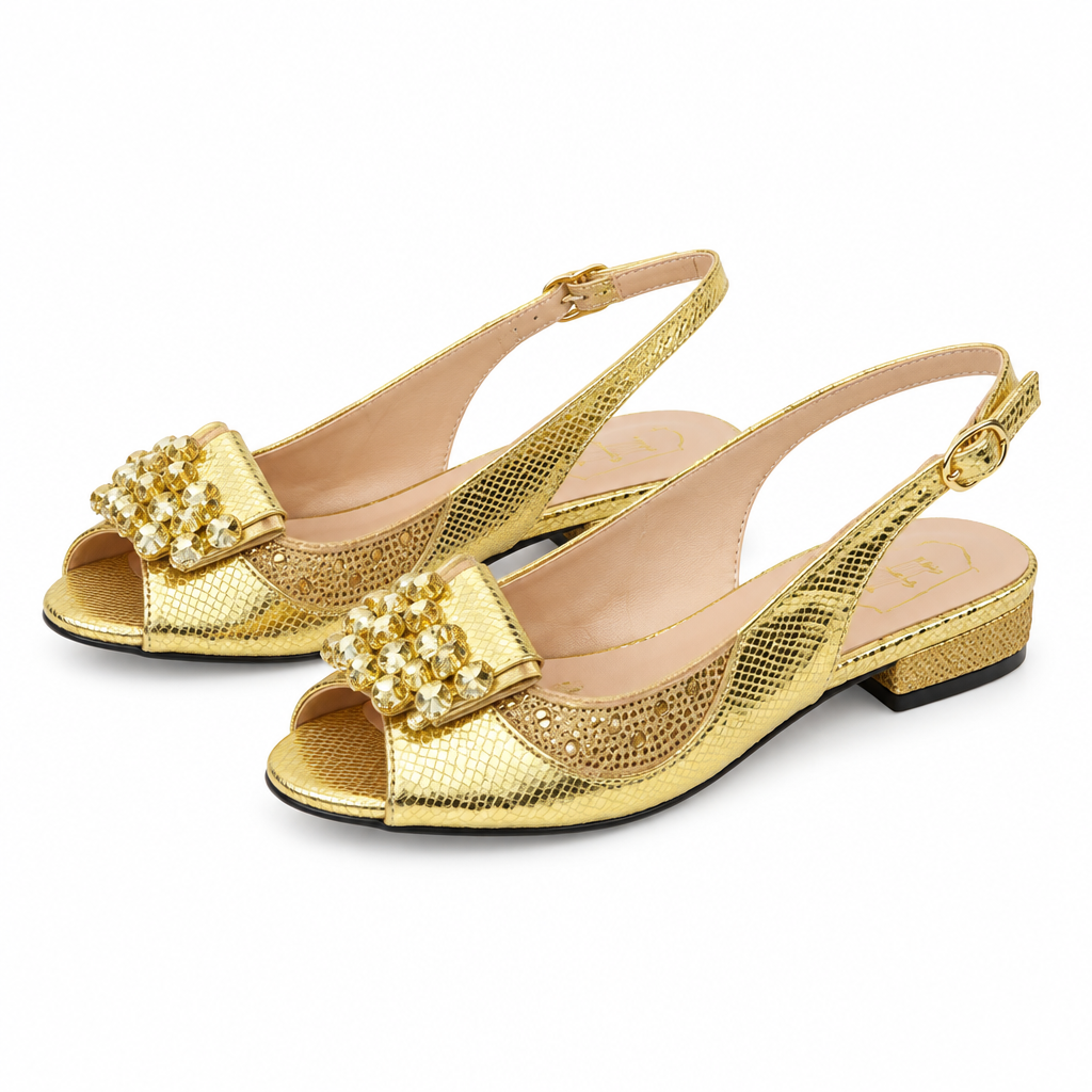 Gold slingback flats pair on white background