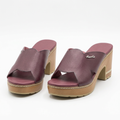 Pair of plum cross-strap platform block-heel mules on white