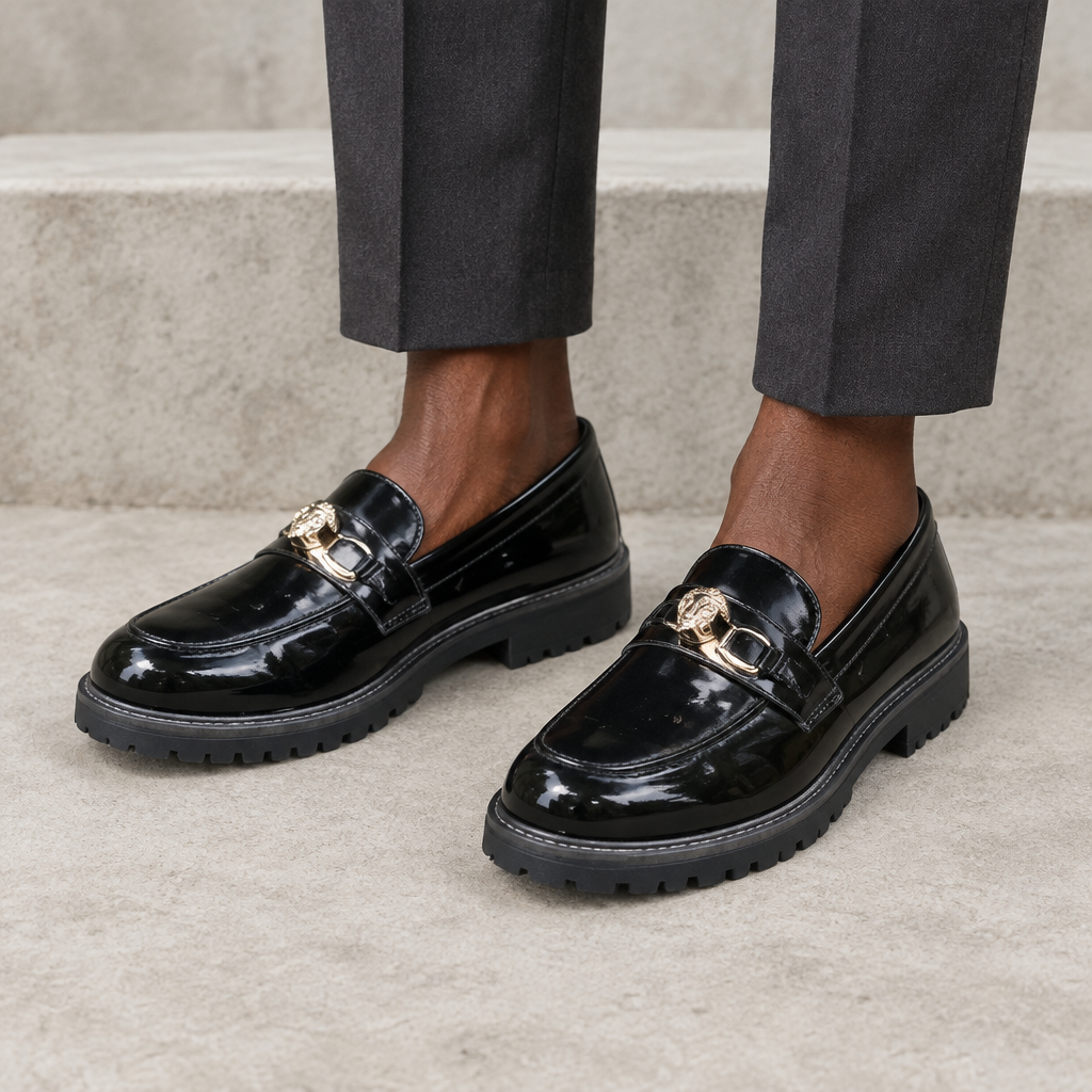 Black chunky-sole loafers worn on both feet