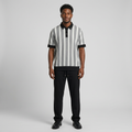 Nigerian man wearing grey striped polo and black trouser set