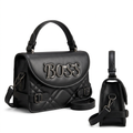 Black quilted handbag front and visible side angles together on white