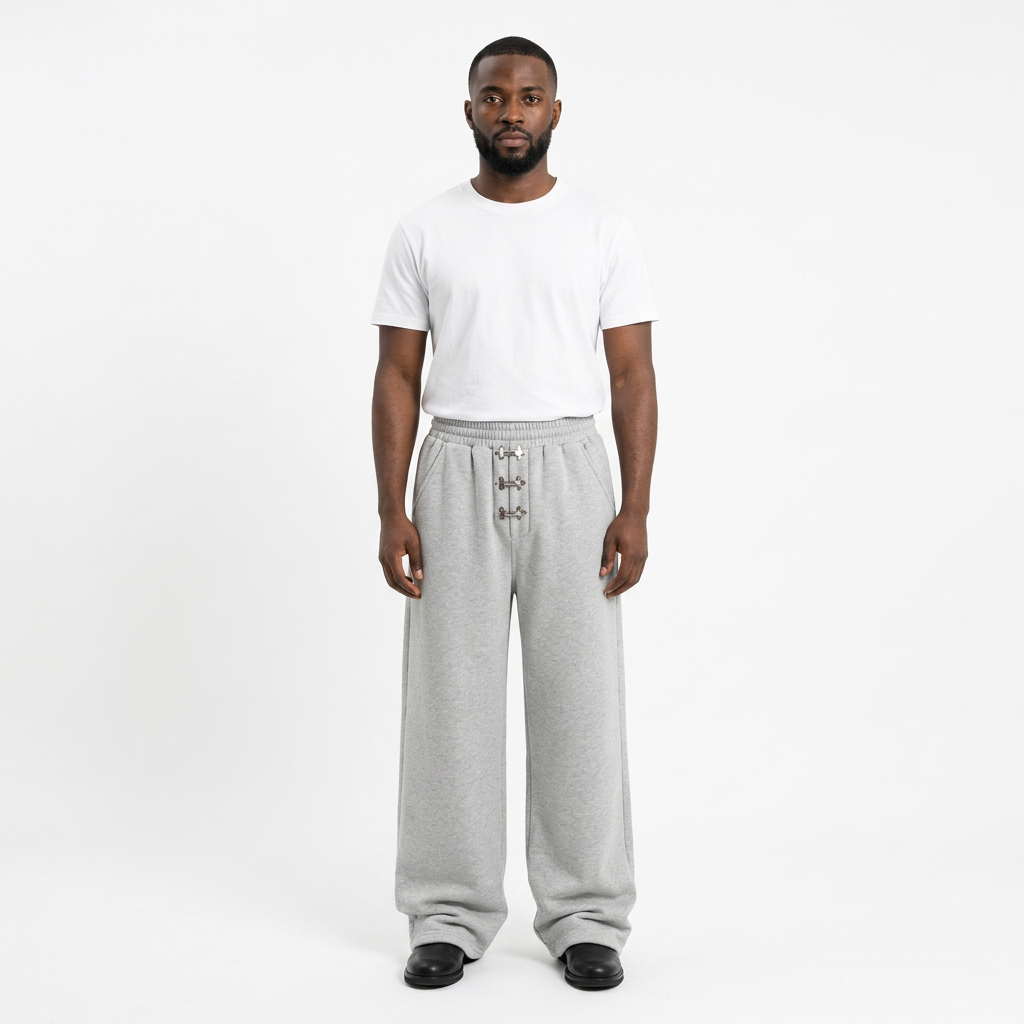Full-body male model wearing light-grey metal-clasp wide-leg trousers