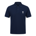 Navy short-sleeve collared polo with a small white heart-and-letter chest detail