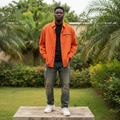 Nigerian male model wearing orange striped oversized embroidered long-sleeve shirt – full body lifestyle shot